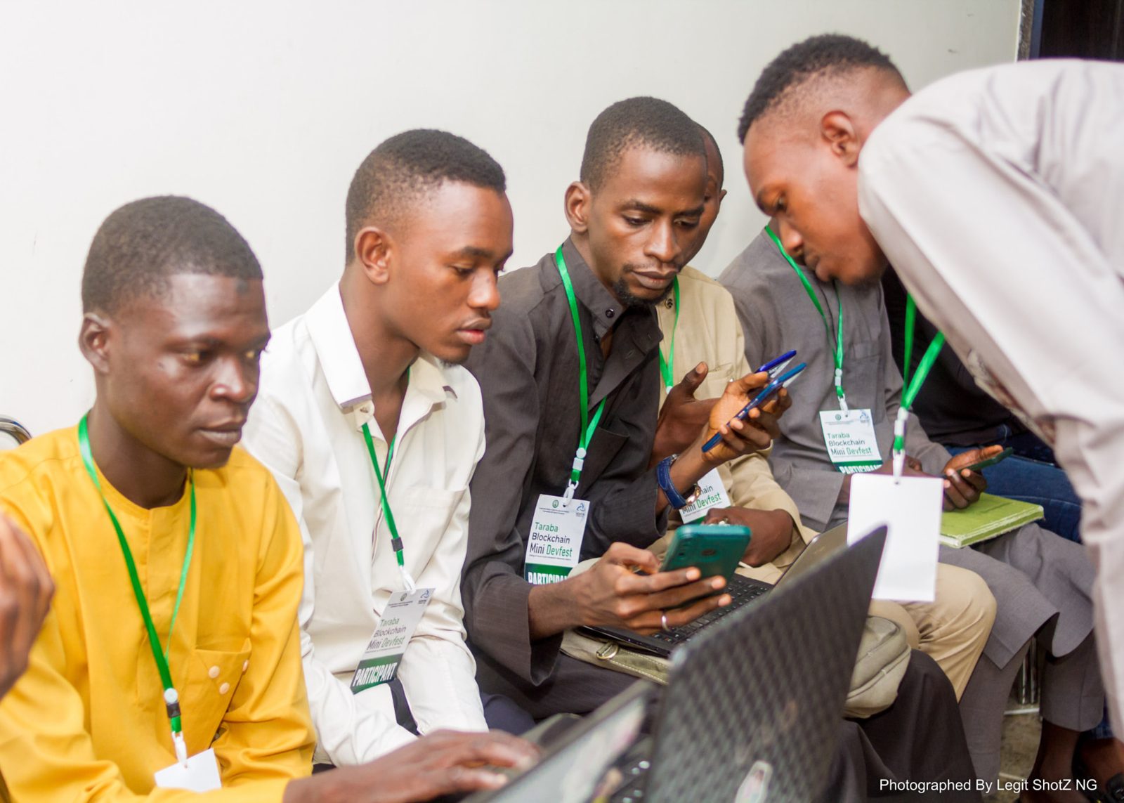 Small team collaborating around a laptop and phone