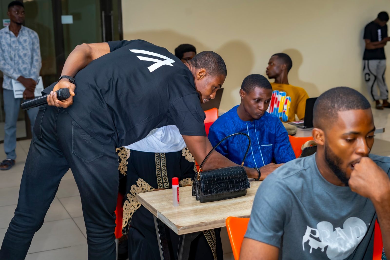 Mentor guiding learners at laptops during a workshop